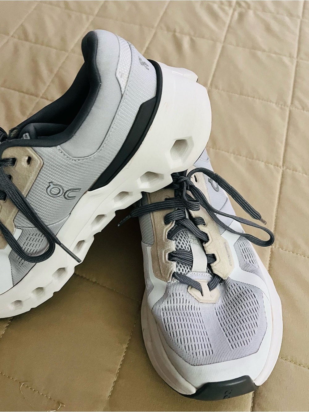 On Running women’s Sneakers in White, Gray & Beige. In good condition.